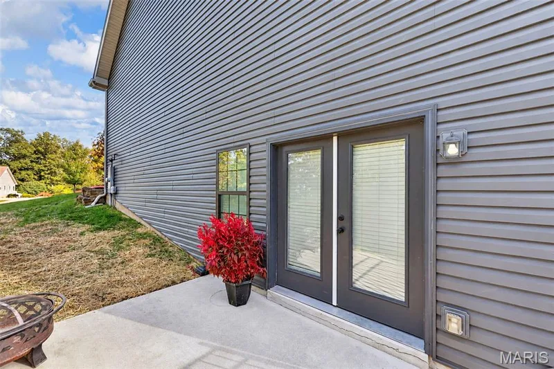 Side Walk-out from Basement with a gate entrance to backyard. — 305 Crescent Oak Court, New Melle, MO 63385