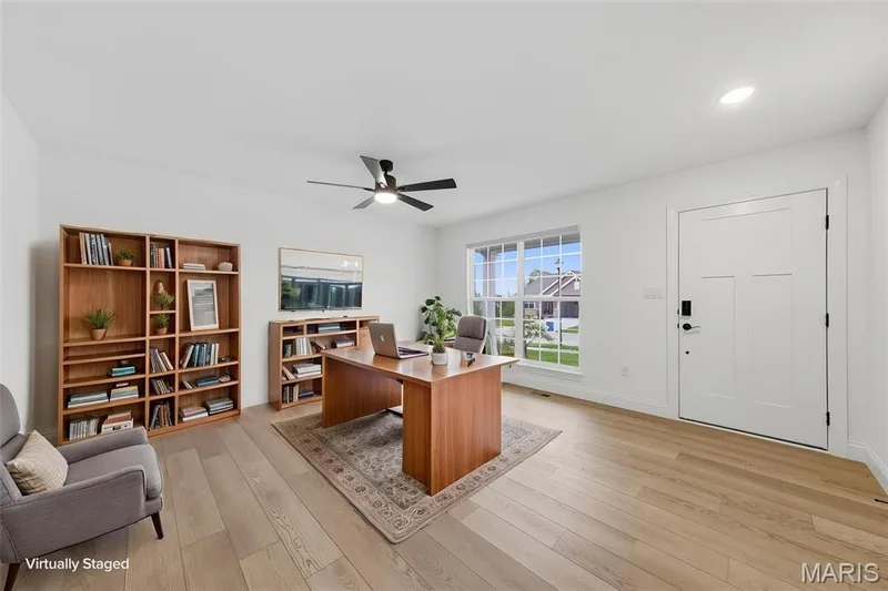 Wood-finish flooring, white walls, ceiling fan, recessed lighting, and a white paneled door — 8 Shady Elm Court, St Charles, MO 63301