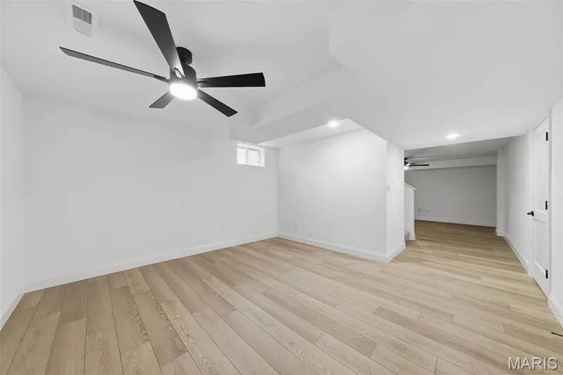 Wood-finish flooring, recessed lighting, ceiling fan, and a louvered door — 8 Shady Elm Court, St Charles, MO 63301