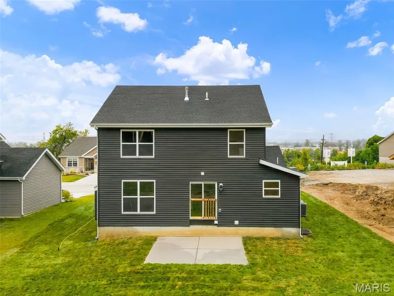 Two-story exterior with horizontal siding, a dark shingle roof, and multiple windows — 8 Shady Elm Court, St Charles, MO 63301