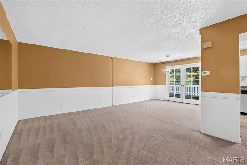 Living room with carpeting and access to deck — 1511 Hampton Hall Drive #18, Chesterfield, MO 63017