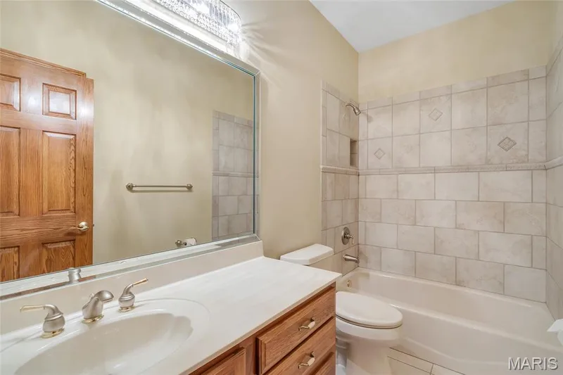 Thoughtfully designed, the main-floor hall bath includes a linen closet for added convenience and organization. — 4030 Austin Drive, St Charles, MO 63304