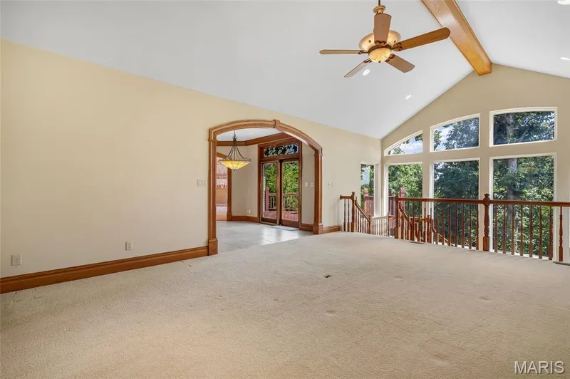 The spacious living room showcases beautiful wooded views, creating a bright and welcoming atmosphere. — 4030 Austin Drive, St Charles, MO 63304