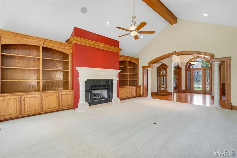 Designed for both comfort and entertaining, the living room showcases a beautiful gas fireplace surrounded by custom built-in shelving, creating an inviting space to gather and relax. — 4030 Austin Drive, St Charles, MO 63304