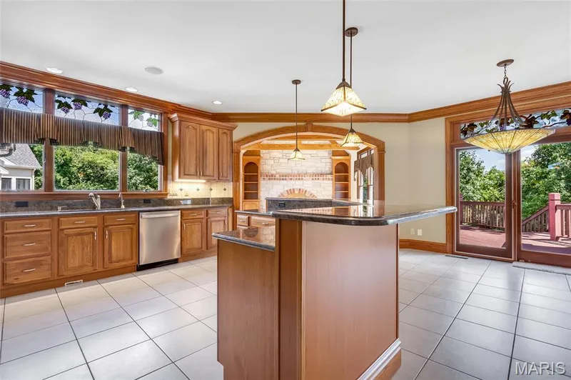 Filled with natural light, the kitchen is as functional as it is inviting, offering ample space for meal preparation, gathering, and entertaining while enjoying the views. — 4030 Austin Drive, St Charles, MO 63304