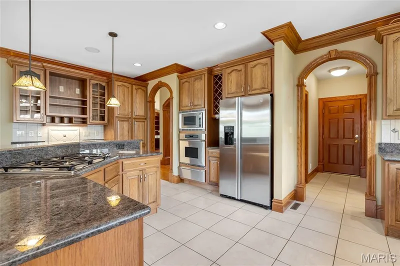 The well-appointed kitchen combines style and performance with stainless steel appliances, a built-in oven and microwave, and a warming drawer that is perfect for entertaining and holiday gatherings. — 4030 Austin Drive, St Charles, MO 63304