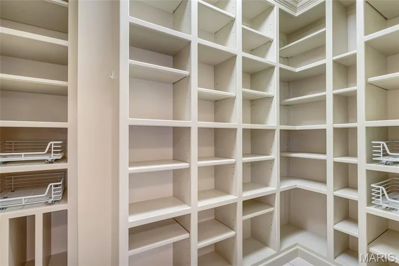 Custom walk-in pantry conveniently located between the kitchen and garage entry, providing exceptional storage and everyday convenience. — 4030 Austin Drive, St Charles, MO 63304