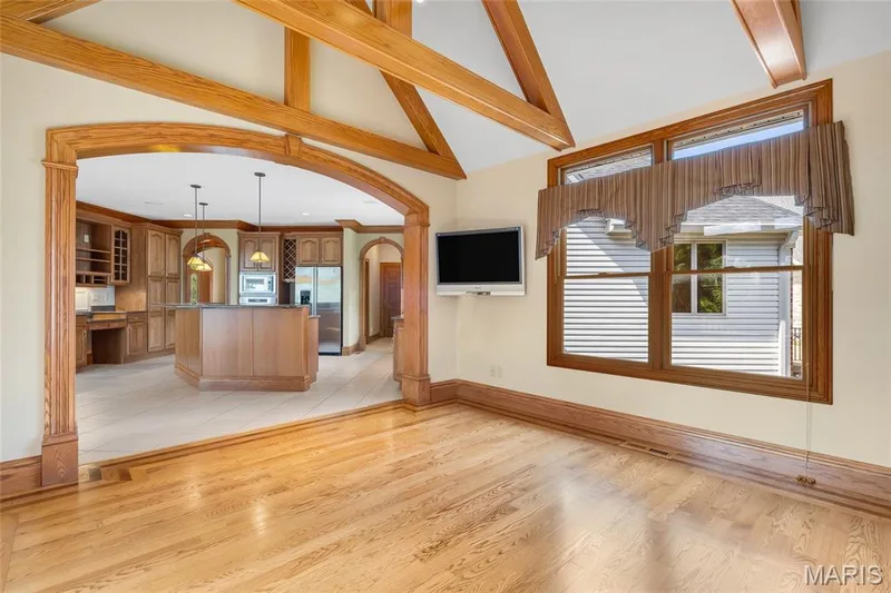 Adjacent to the kitchen, the hearth room features a cozy fireplace and an abundance of natural light, creating a bright and welcoming space for relaxing, entertaining, or enjoying peaceful wooded views. — 4030 Austin Drive, St Charles, MO 63304