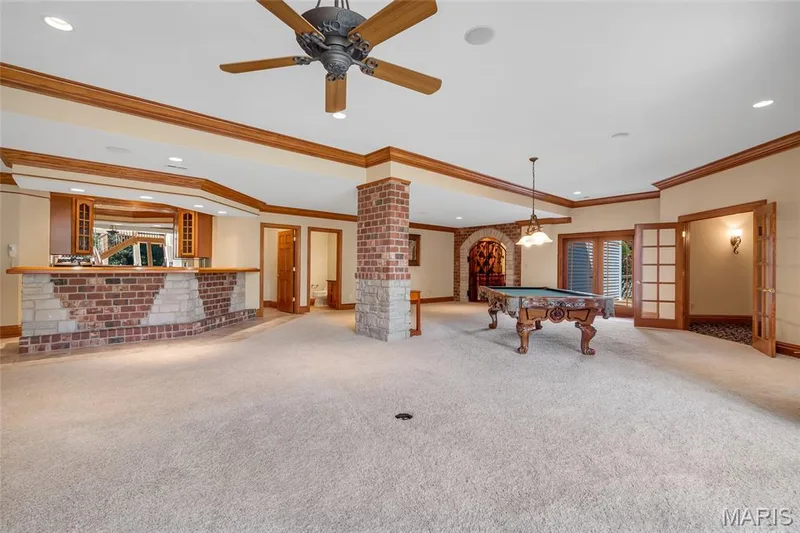 Everywhere you look, you'll find thoughtful custom details, from extensive crown molding and impressive 9-foot-plus ceilings to oversized baseboards, a stylish wet bar, and rich stone and brick architectural features. — 4030 Austin Drive, St Charles, MO 63304