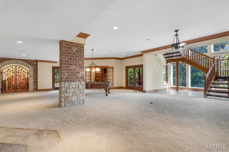 Floor-to-ceiling windows flood the lower level with natural light, while the tall ceilings create a bright, welcoming space that make it feel like a natural extension of the main living area. — 4030 Austin Drive, St Charles, MO 63304