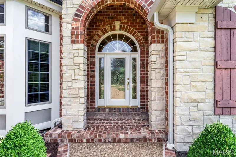 An inviting arched covered porch adds timeless architectural charm and creates a warm welcome for guests. — 4030 Austin Drive, St Charles, MO 63304