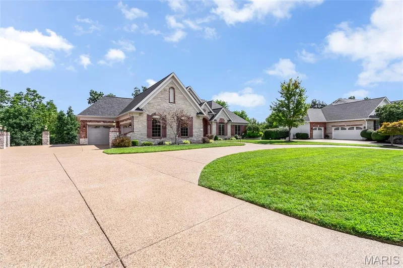Designed with both convenience and functionality in mind, the oversized 3-car garage and aggregate circular driveway provide generous parking accommodations for family gatherings and entertaining. — 4030 Austin Drive, St Charles, MO 63304