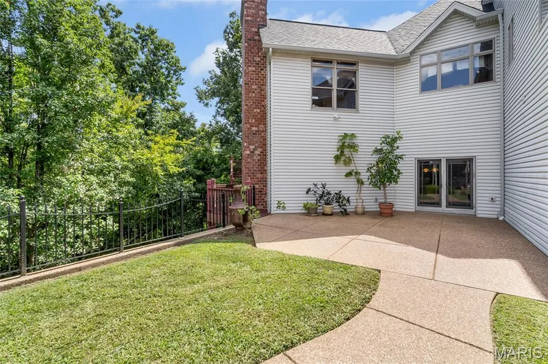 Seamlessly blending indoor and outdoor living, the recreation room opens to a generous patio with additional green space, providing endless opportunities. — 4030 Austin Drive, St Charles, MO 63304