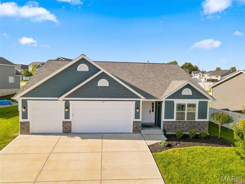 Three-car garage, stone and siding exterior, concrete driveway, front entry. — 130 Pomodora Circle, Wentzville, MO 63385