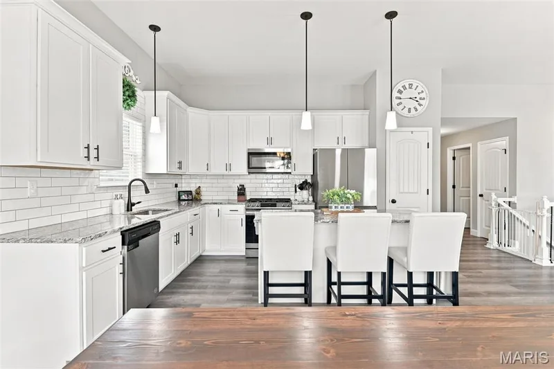 Upgraded 42" upper cabinets, granite counters, luxury vinyl flooring, pendent lighting — 130 Pomodora Circle, Wentzville, MO 63385