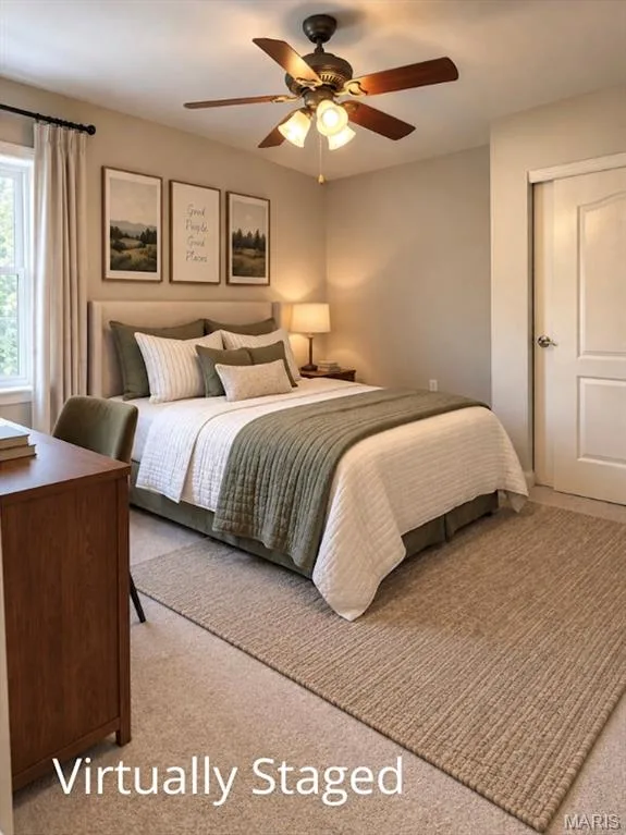 Neutral wall paint, ceiling fan with integrated lighting, window with light-colored drapes, plush carpet flooring, and a white closet door — 3105 Wheeling Drive, St Charles, MO 63301