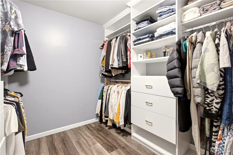 Custom closet system with multiple shelving units, integrated drawers, and hanging rods — 308 Graywynd Court, Lake St. Louis, MO 63367