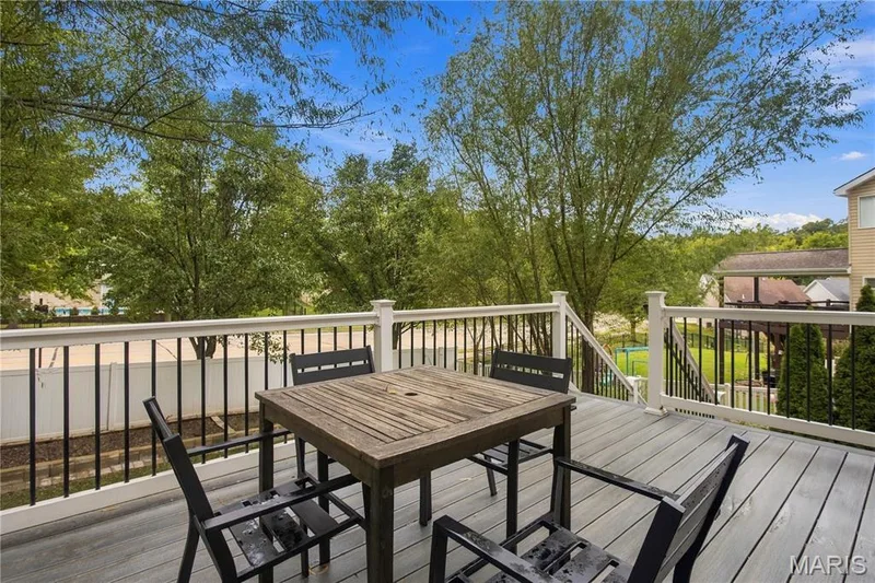 Expansive composite deck with white railings and black balusters — 308 Graywynd Court, Lake St. Louis, MO 63367