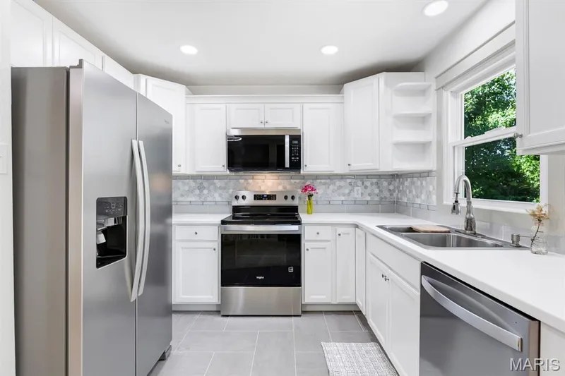 White custom cabinetry, stainless steel appliances and very modern ceramic tile & flooring — 3424 La Salle Drive, St Charles, MO 63301
