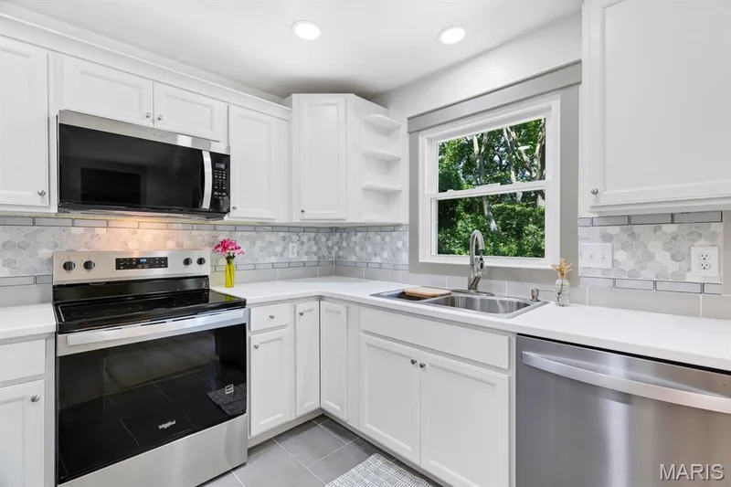 White custom cabinetry, stainless steel appliances and very modern ceramic tile & flooring — 3424 La Salle Drive, St Charles, MO 63301