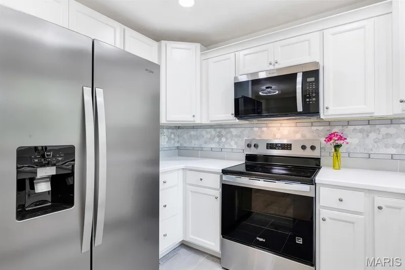 White custom cabinetry, stainless steel appliances and very modern ceramic tile & flooring — 3424 La Salle Drive, St Charles, MO 63301