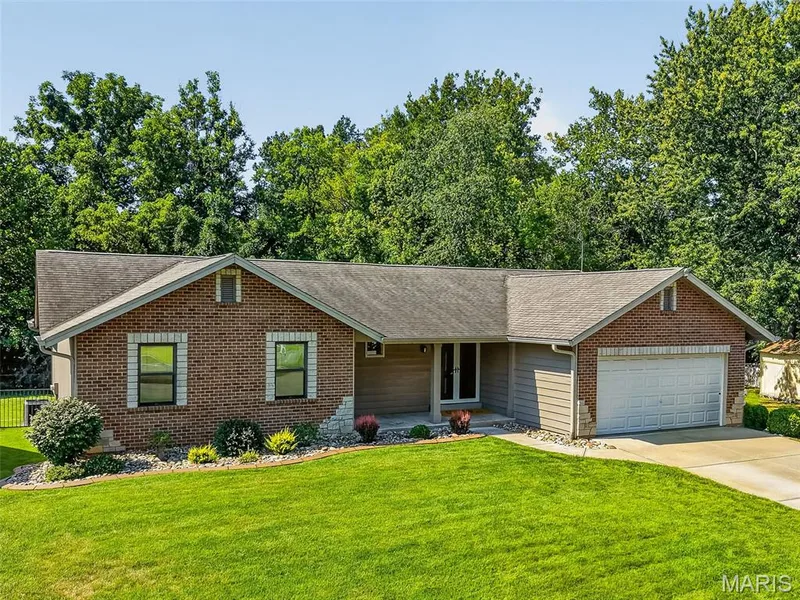 Brick and siding exterior with stone accents, attached garage, and a concrete driveway — 19 Novella Drive, St Peters, MO 63376