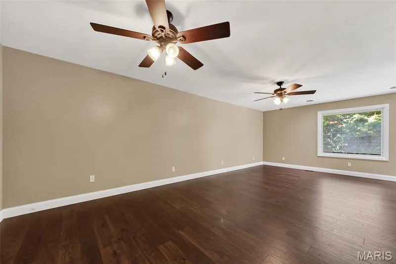 Spacious interior with rich wood-finish flooring — 19 Novella Drive, St Peters, MO 63376