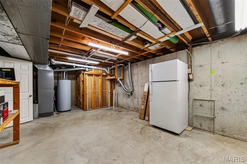 Unfinished basement with concrete flooring, exposed wood ceiling joists, and concrete foundation walls — 19 Novella Drive, St Peters, MO 63376