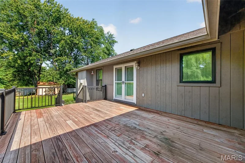 Expansive wood deck with metal railings and dual French doors — 19 Novella Drive, St Peters, MO 63376