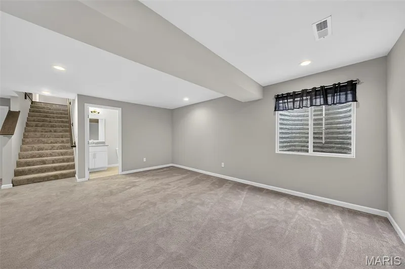 Carpeted flooring throughout, recessed lighting, and a full staircase — 622 Cruden Bay Court, Dardenne Prairie, MO 63368