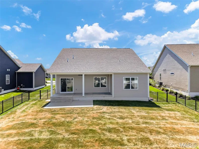 Rear exterior with a covered patio, concrete slab, and sliding glass door — 622 Cruden Bay Court, Dardenne Prairie, MO 63368