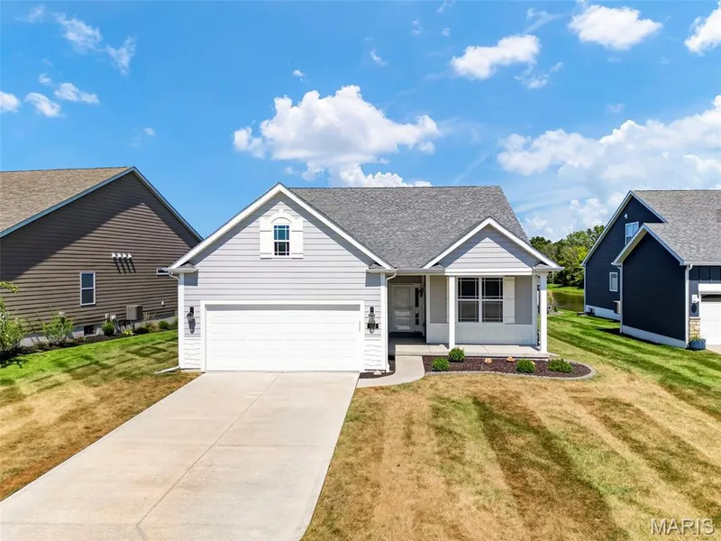 Light gray siding exterior with white trim, attached two-car garage, concrete driveway, and front landscaping — 622 Cruden Bay Court, Dardenne Prairie, MO 63368