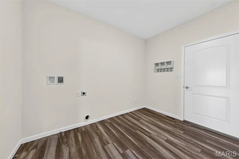 Wood-finish flooring, light-toned walls, and a white paneled door — 622 Cruden Bay Court, Dardenne Prairie, MO 63368