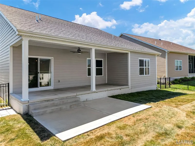 Covered patio with a ceiling fan, concrete steps, and a sliding glass door — 622 Cruden Bay Court, Dardenne Prairie, MO 63368