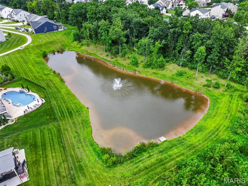 Private pond with water feature, surrounded by mature trees and manicured lawn — 622 Cruden Bay Court, Dardenne Prairie, MO 63368