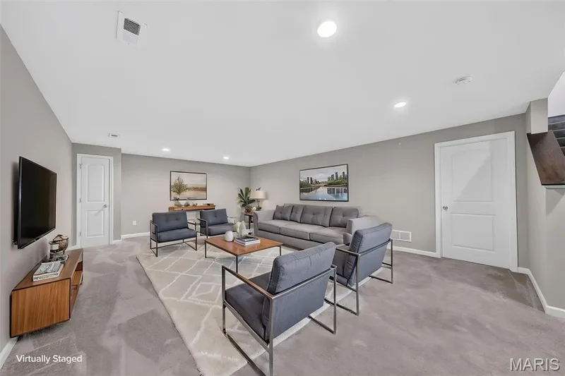 Carpeted living area with recessed lighting, light gray walls, and white trim — 622 Cruden Bay Court, Dardenne Prairie, MO 63368