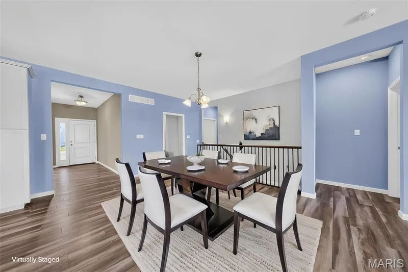 Wood-finish flooring throughout, light blue wall finishes, and a traditional chandelier — 622 Cruden Bay Court, Dardenne Prairie, MO 63368