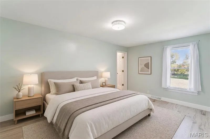 Light-hued walls complement the wood-finish flooring — 435 Highway T, Foristell, MO 63348
