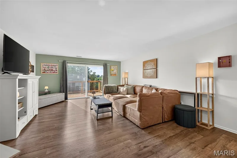 Large Living Room with Plank Flooring and Large Sliding Door to the Deck — 74 Sugar Glen Court #6, St Peters, MO 63376