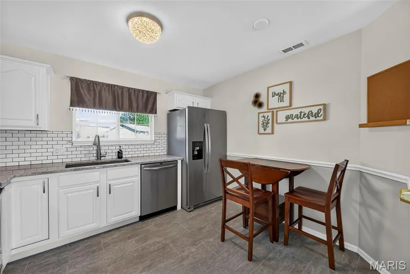 Eat In Kitchen with Ceramic Tile Flooring and Stainless Steel Appliances — 74 Sugar Glen Court #6, St Peters, MO 63376