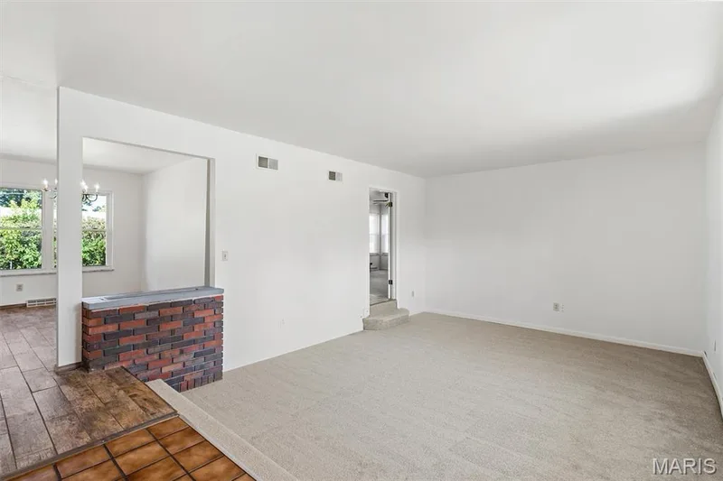 View from entry foyer of spacious sunken living room and dining room — 109 Meadowlark Lane, St Charles, MO 63301
