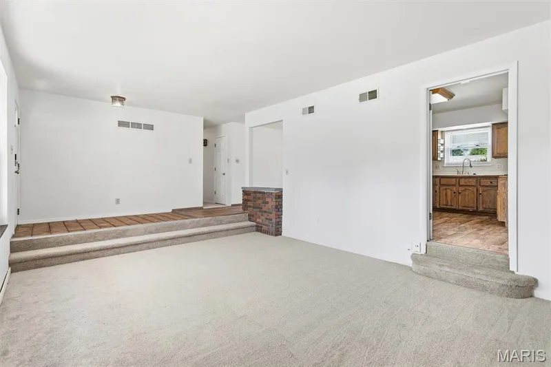 Living room leads into kitchen and family room — 109 Meadowlark Lane, St Charles, MO 63301
