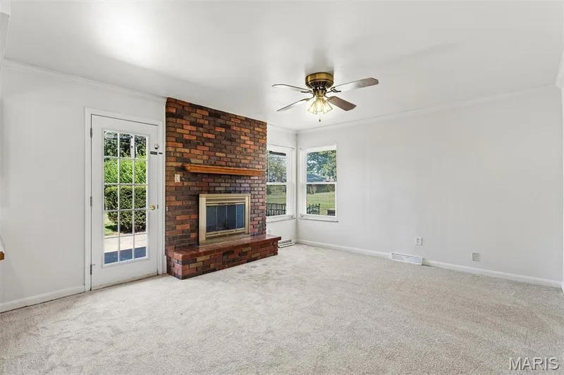 Family room features door leading to backyard patio — 109 Meadowlark Lane, St Charles, MO 63301