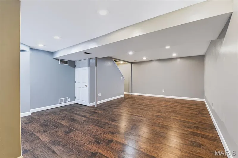 Recessed lighting, wood-finish flooring, white trim, and light gray walls — 1314 Warrior Song Way, O'Fallon, MO 63366