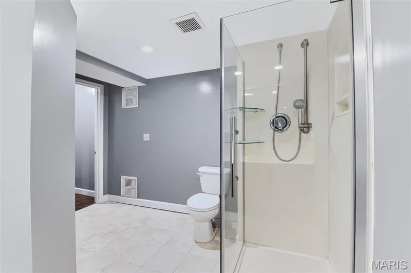 Glass-enclosed shower with a handheld showerhead and built-in shelving — 1314 Warrior Song Way, O'Fallon, MO 63366