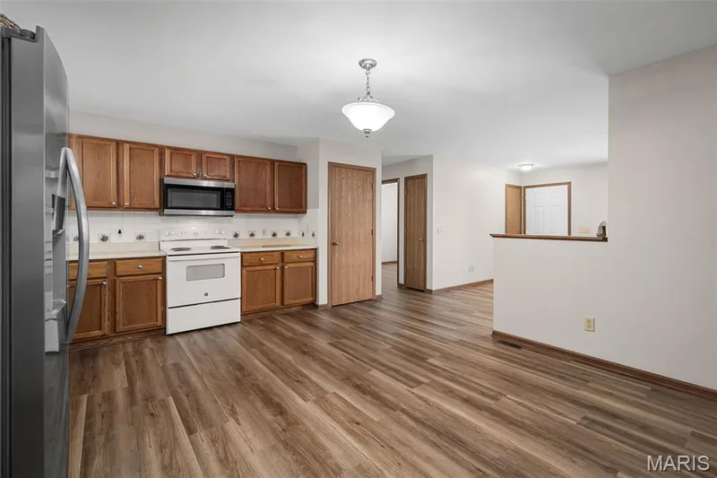 Open, eat-in kitchen with new flooring and paint throughout. — 86 Sun Haven Court, Wentzville, MO 63385