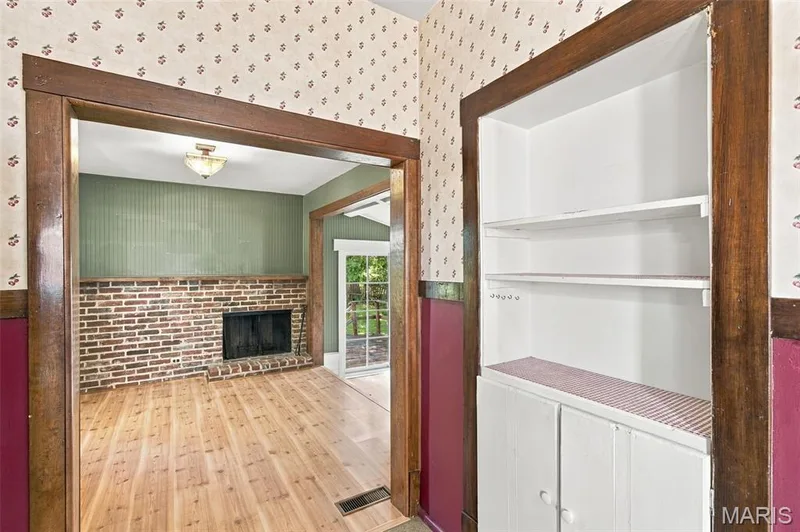 Kitchen looks into the back family room with cozy fireplace — 201 Perry Street, St Charles, MO 63301