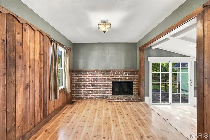 Back family Room features a cozy fireplace — 201 Perry Street, St Charles, MO 63301