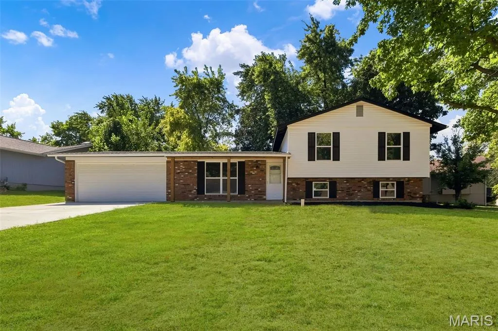 AI-enhanced image. Grass digitally restored to illustrate anticipated appearance after lawn repair and seeding following recent sewer lateral work. — 18 Craigwood Drive, St Peters, MO 63376