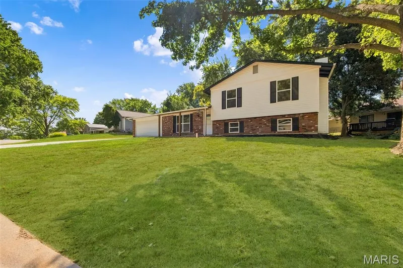 AI-enhanced image. Grass digitally restored to illustrate anticipated appearance after lawn repair and seeding following recent sewer lateral work. — 18 Craigwood Drive, St Peters, MO 63376